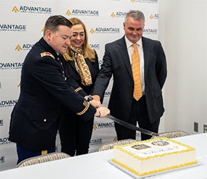 CPT McCrary, Ms. Kummings and Jim Ruark, Chief Operating Officer, Advantage Surveillance, cutting the ceremonial cake.