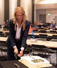 April Arnzen, EVP and Chief People Officer, Micron Technology, Inc. cuts the ceremonial cake.