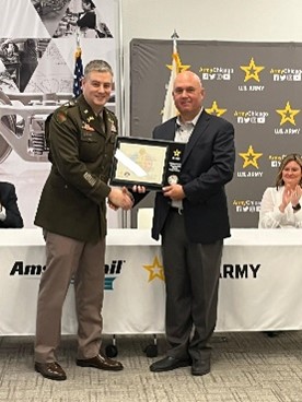 LTC Culver presents the ceremonial plaque highlighting the PaYS partnership to Mr. Carter, CEO for Amsted Rail.