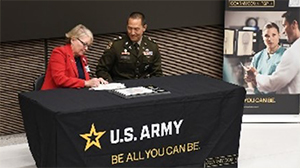 Ms. Dolohanty and LTC Kim signing the ceremonial agreement