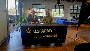 Mr. Blackman and MAJ Perrier sit at the table before signing ceremonial MOA