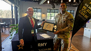 Mr. Blackman and MAJ Perrier pose with the PaYS Ceremonial Plaque. Mr. Blackman and MAJ Perrier pose with the PaYS Ceremonial Plaque.
