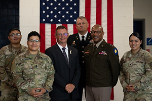 Soldiers join MG Rodney Boyd and Mr. James Derkinski in a picture after the ceremony Soldiers join MG Rodney Boyd and Mr. James Derkinski in a picture after the ceremony