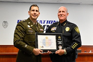 MAJ Holtzman presents plaque to Chief W. Howard Harrison 