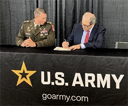 Troy Streckenbach, County Executive, Brown County, WI signs MOA while LTC Eliot Proctor, Commander, Milwaukee Recruiting Battalion looks on