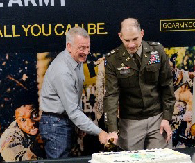 LTC James and Mr. Clark share in the celebration by cutting the ceremonial cake