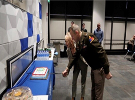 COL Soyka and Mrs. Tomblin participate in the cake-cutting at the close of the signing ceremony
