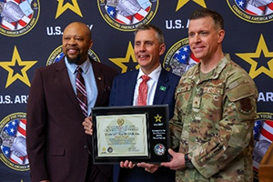 PaYS Program Manger Antonio Johnson, Governor Kelly Armstrong and BG Mitchell Johnson display the Army PaYS commemorative plaque