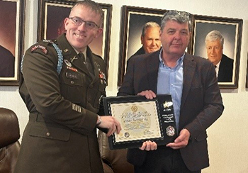 LTC Morris presents the plaque to Mr. Gregory