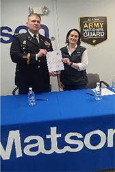 COL Kelsey and Ms. Tungul pose with the signed ceremonial PaYS Memorandum of Agreement.